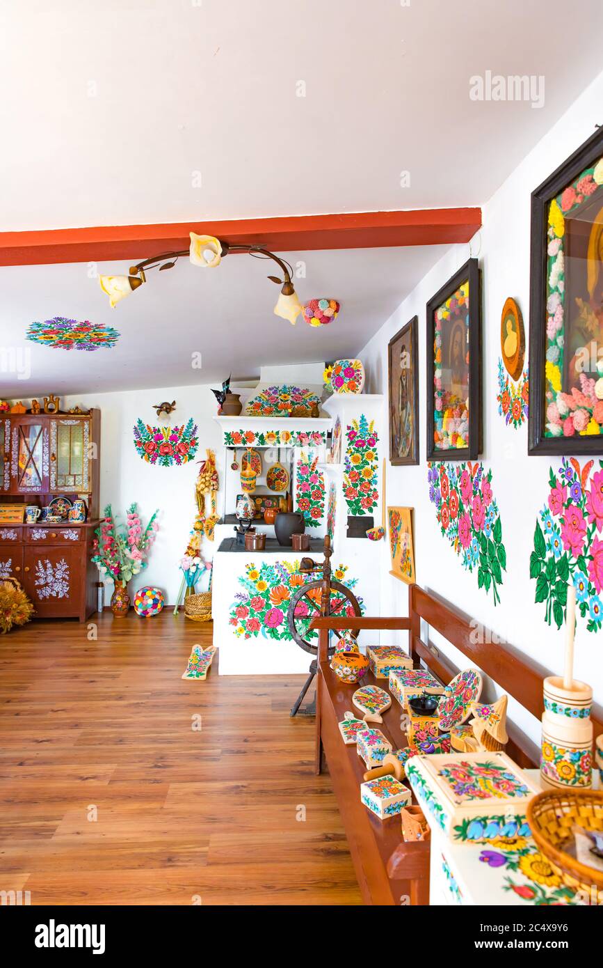 Zalipie, Poland, June 2020: Hand painted floral decorations in cottage house. Polish culture and folk art. Inside souvenir shop with folk craft Stock Photo