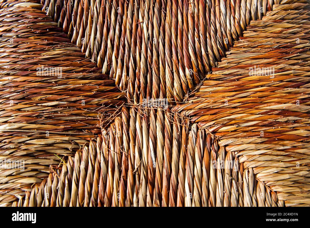 A traditional greek taverna straw chair seat. Top view. Natural background. Stock Photo