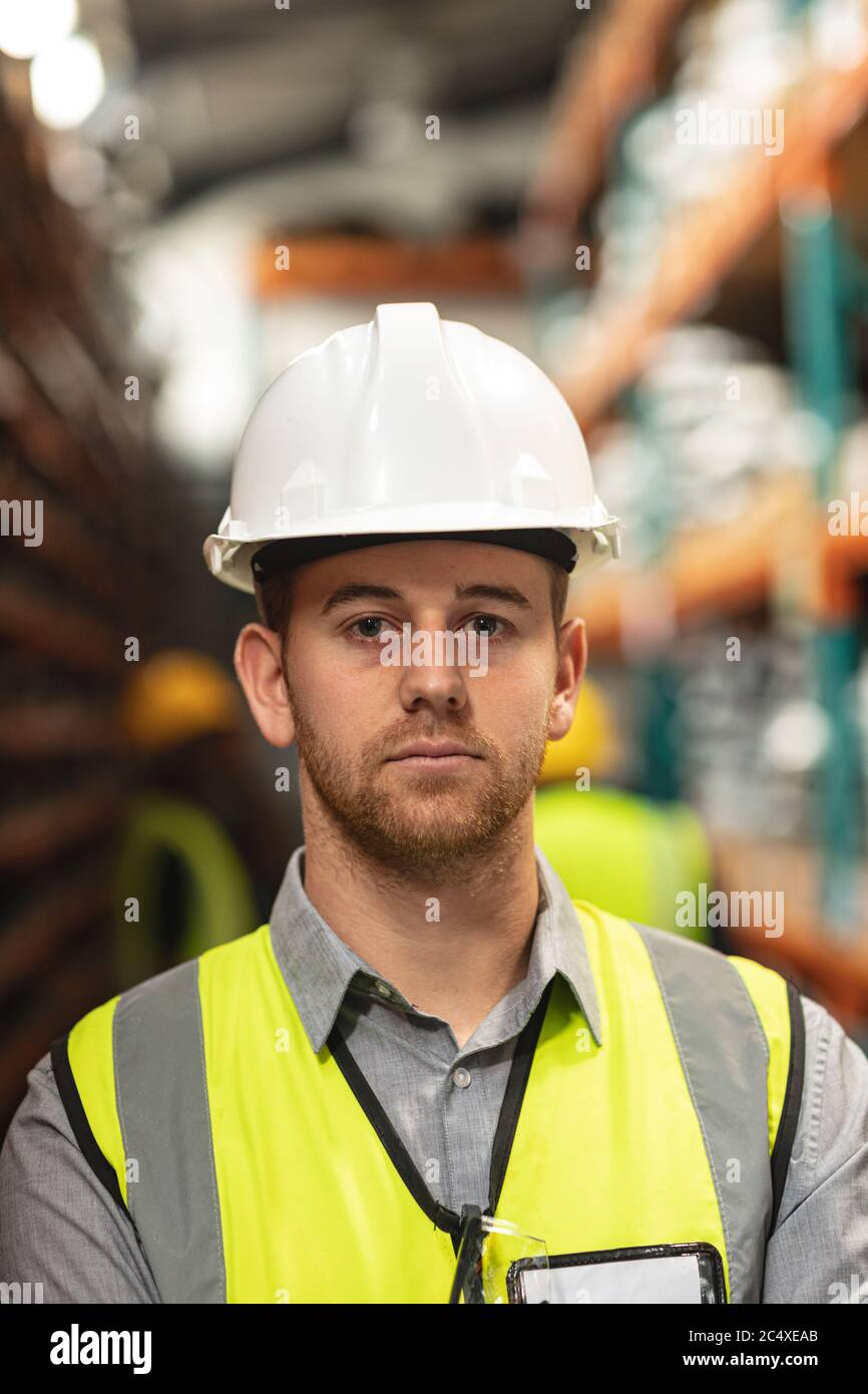 Portrait of a male factory worker wearing a Hi-vis vest and safety helmet Stock Photo