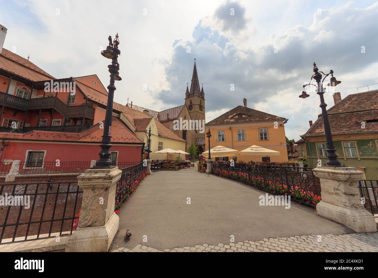 SIBIU, ROMANIA - Circa 2020: Old medieval town brick wall with cloudy blue sky. Beautiful tourist spot in eastern central Europe. Famous bridge of lie Stock Photo