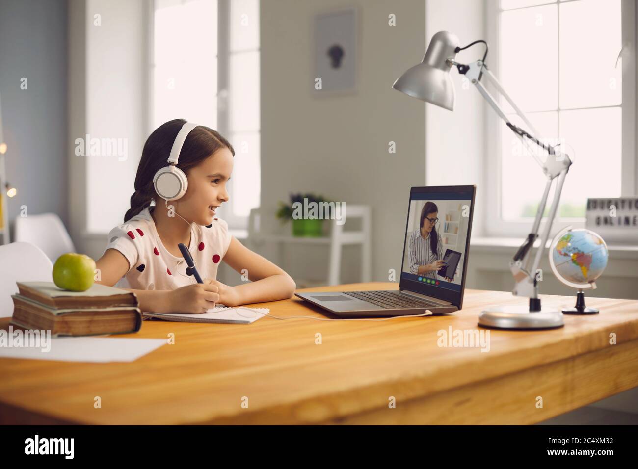 Video Call Lesson Online student education. Schoolgirl listens to a lecture of a teacher ...