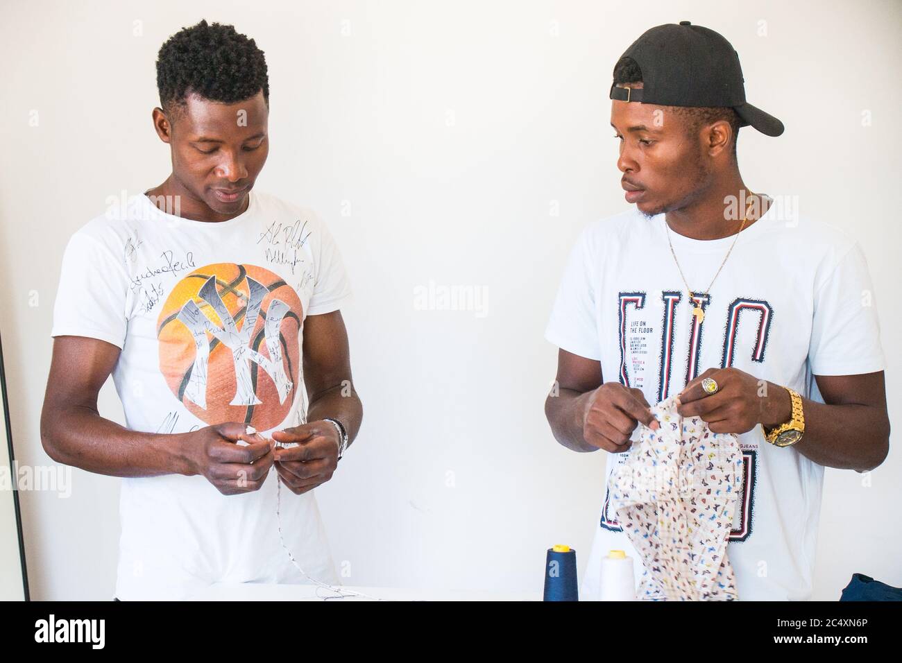 political refugees and African immigrants working on tailoring of the