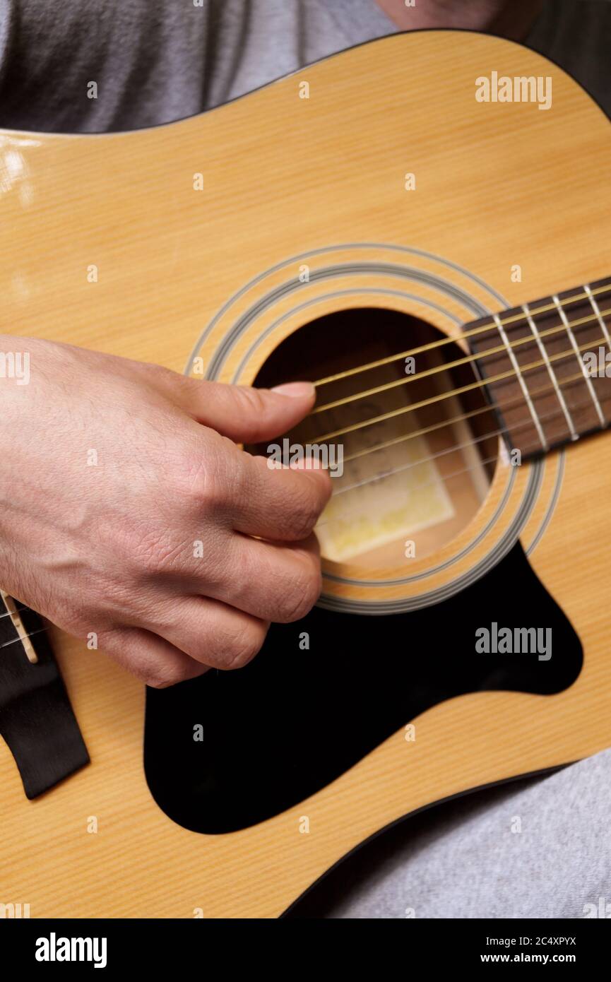 Man playing acoustic guitar Stock Photo