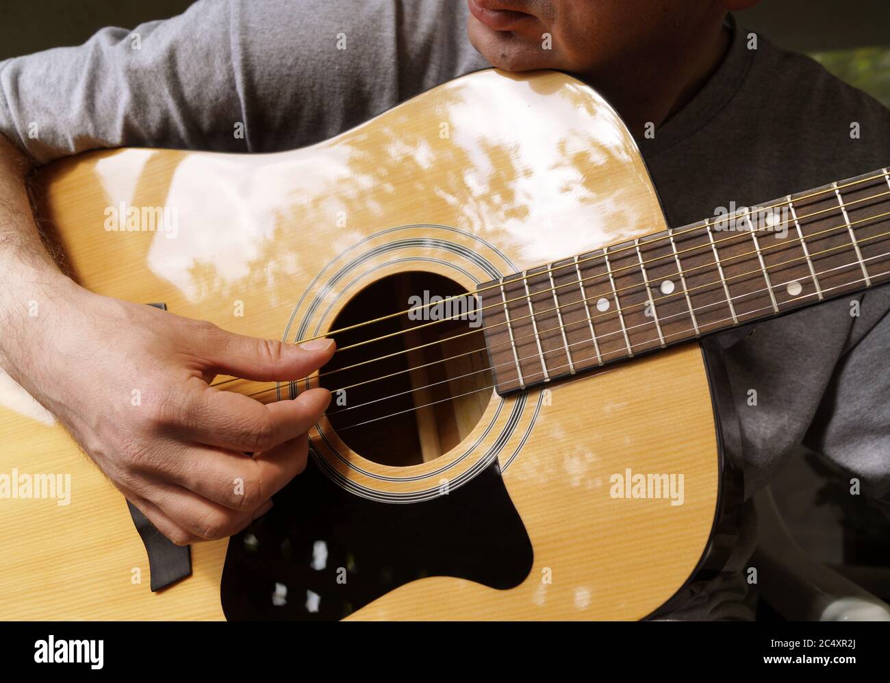Man playing acoustic guitar Stock Photo