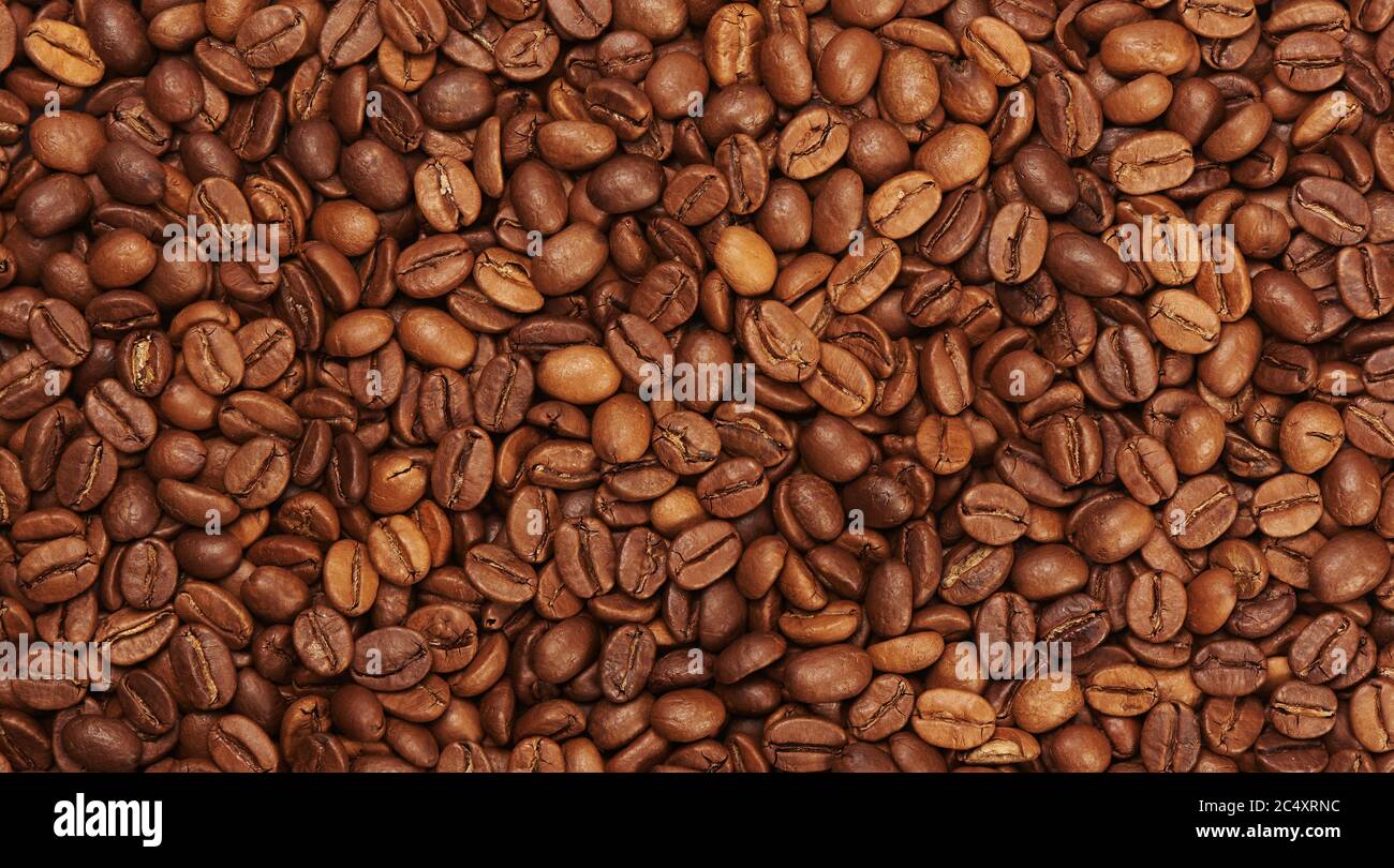 Roasted coffee beans background top view Stock Photo - Alamy