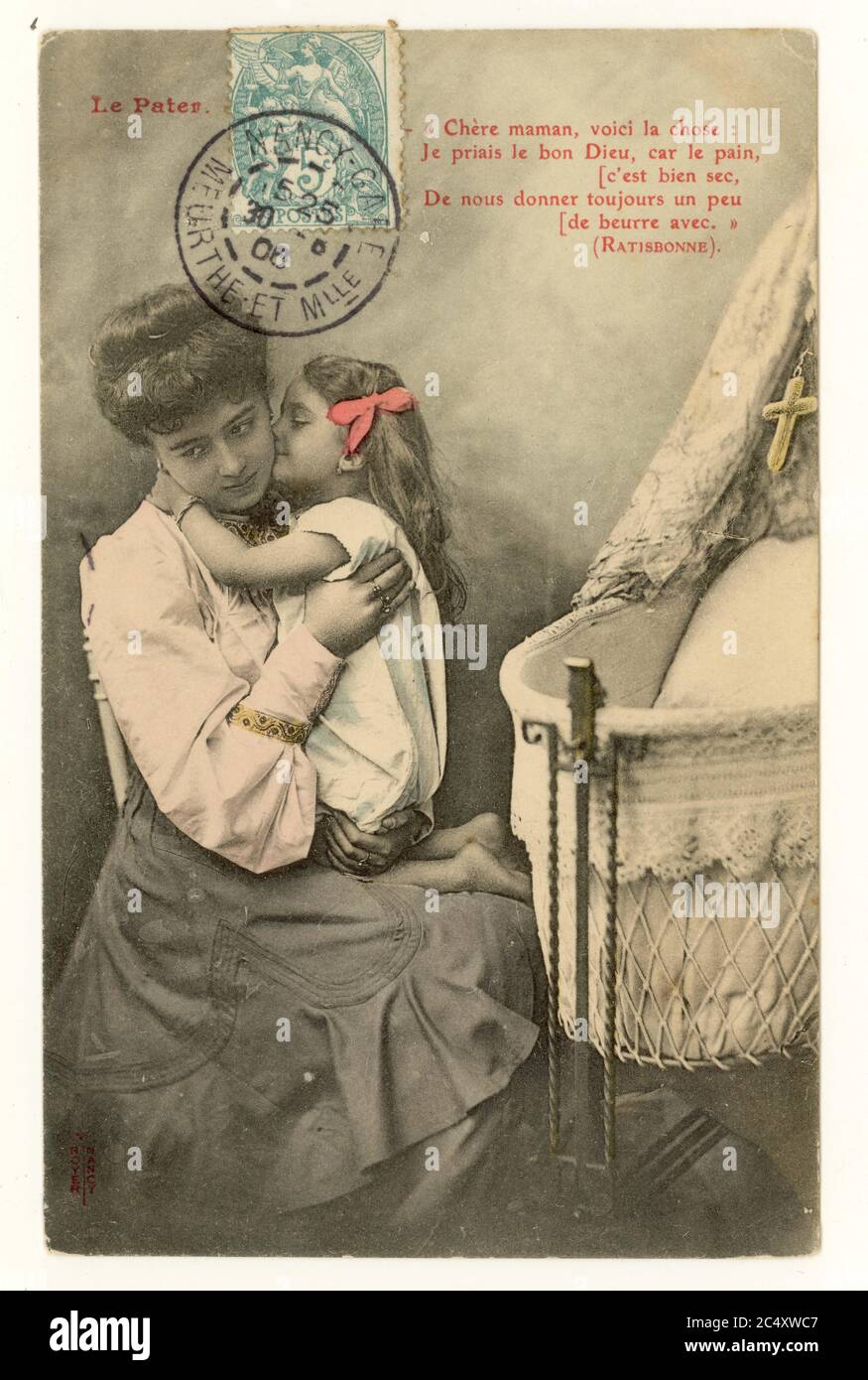 Charming early 1900's French sentimental tinted greetings postcard - mother and cute young daughter, beside cot, Ratisbonne quote,  blue stamp on front of the image, France, posted August 1906. Stock Photo