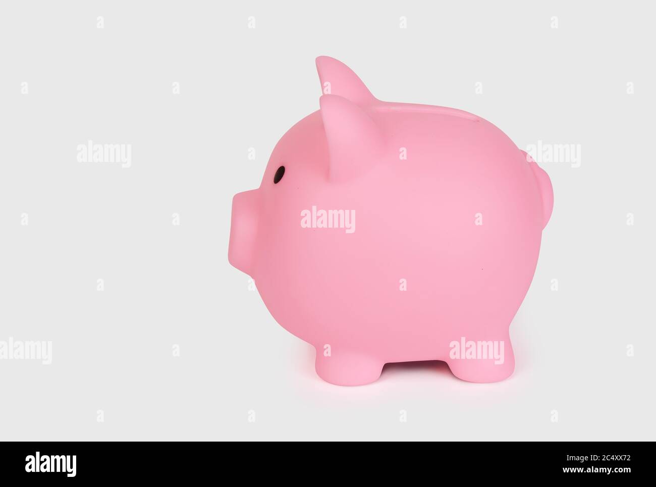 pink piggy bank side view isolated on white background Stock Photo - Alamy