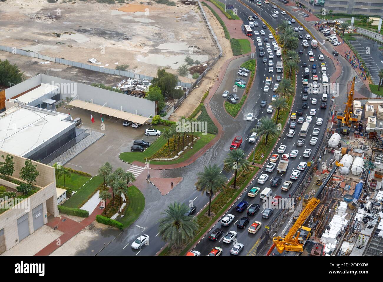 Dubai, UAE - CIRCA 2020: Big long traffic jam caused by have rains. Cars slowly crawling trough big water pods caused by storm water. Stock Photo