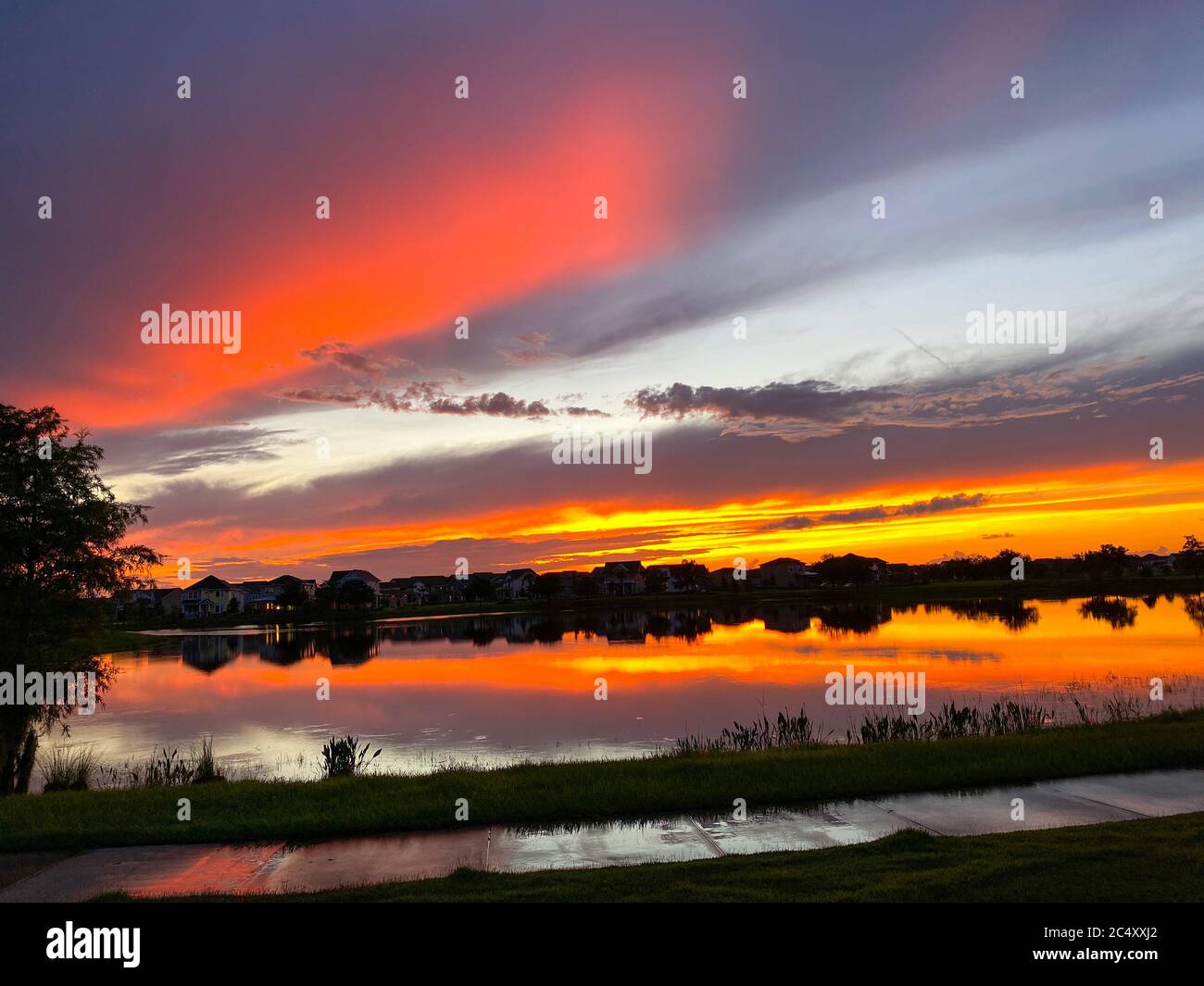 Beautiful pink, orange and blue sunset reflecting on a lake in a ...