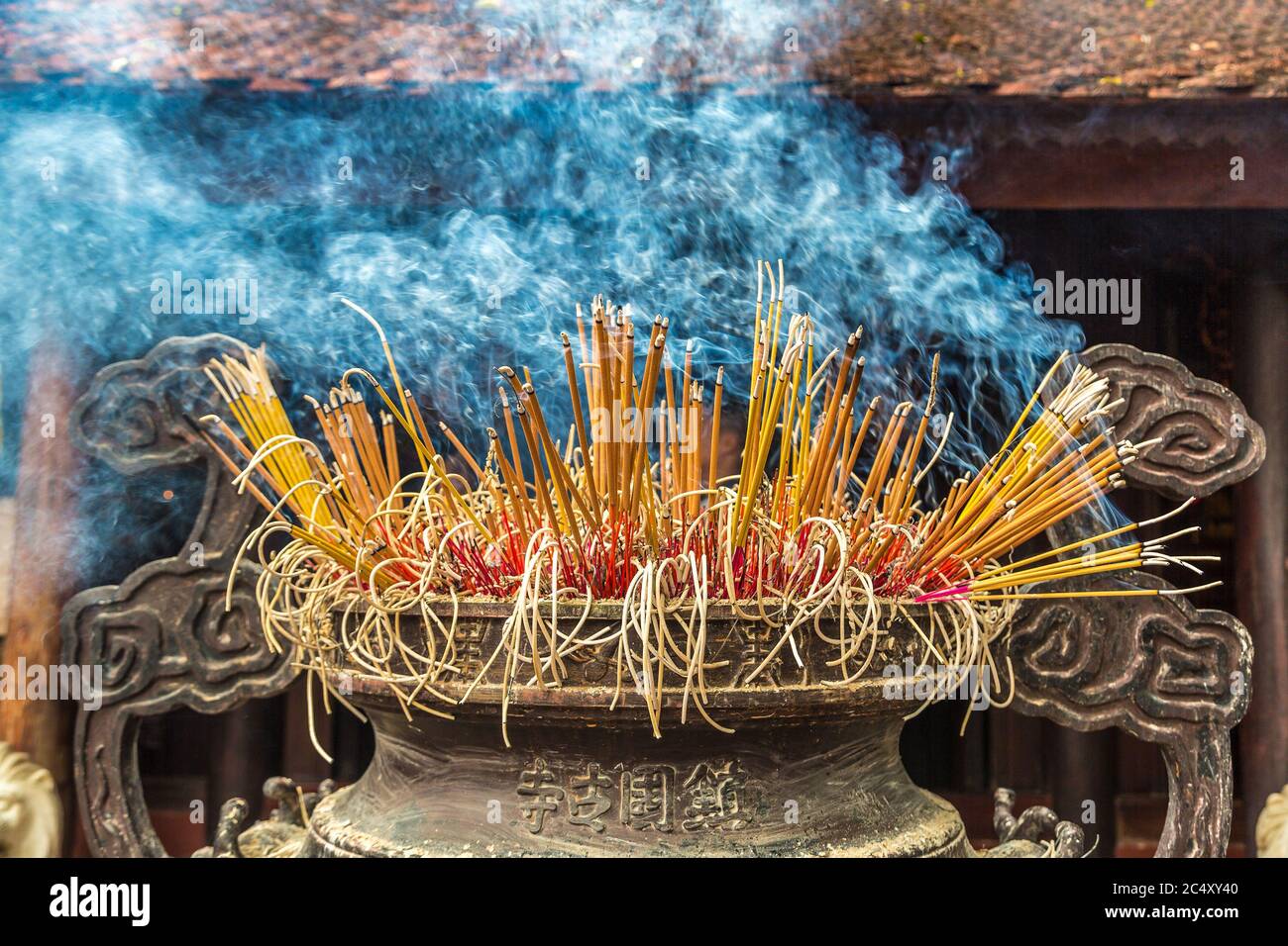 Burning incense sticks in Tran Quoc pagoda in Hanoi, Vietnam in a