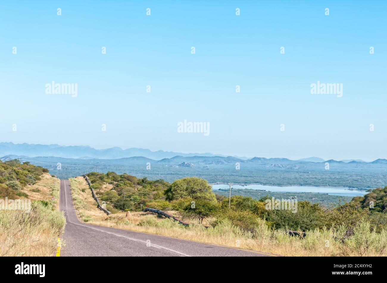 Road C46 to the Ruacana waterfall in the Kunene River. The Calueque Dam in Angola is visible in the back Stock Photo