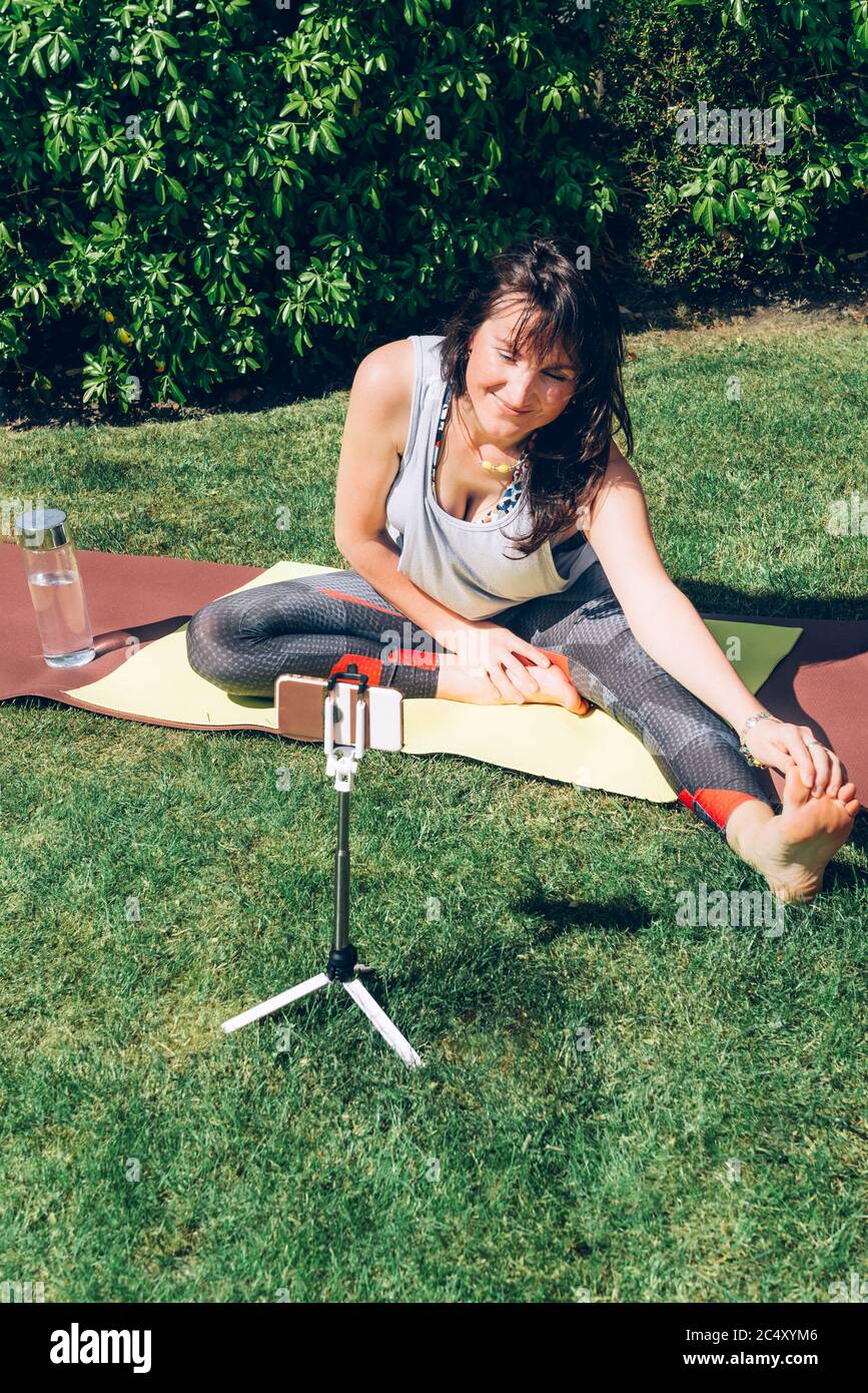 Woman is doing yoga in garden Stock Photo