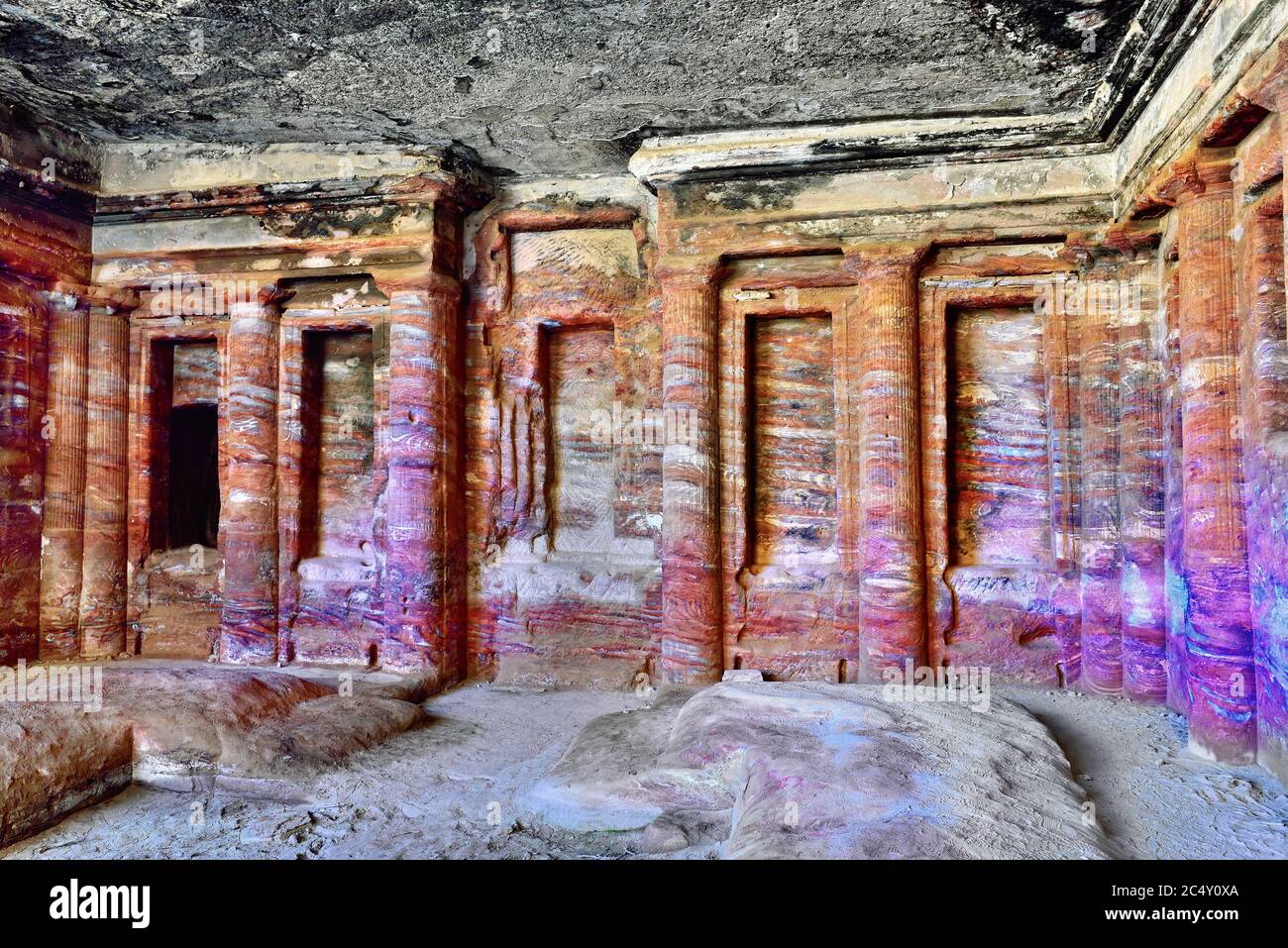 Petra, the Colored Triclinium ( 200 BC) decorated with engaged columns and niches, and was originally covered with painted stucco. The stucco was fall Stock Photo
