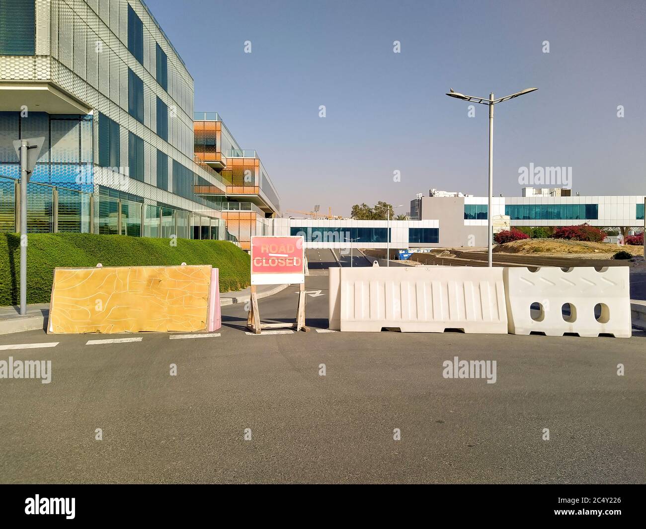 Dubai, UAE - CIRCA 2020: Road closer sign and road blockade near a hospital. Concept of road diversion. Stock Photo