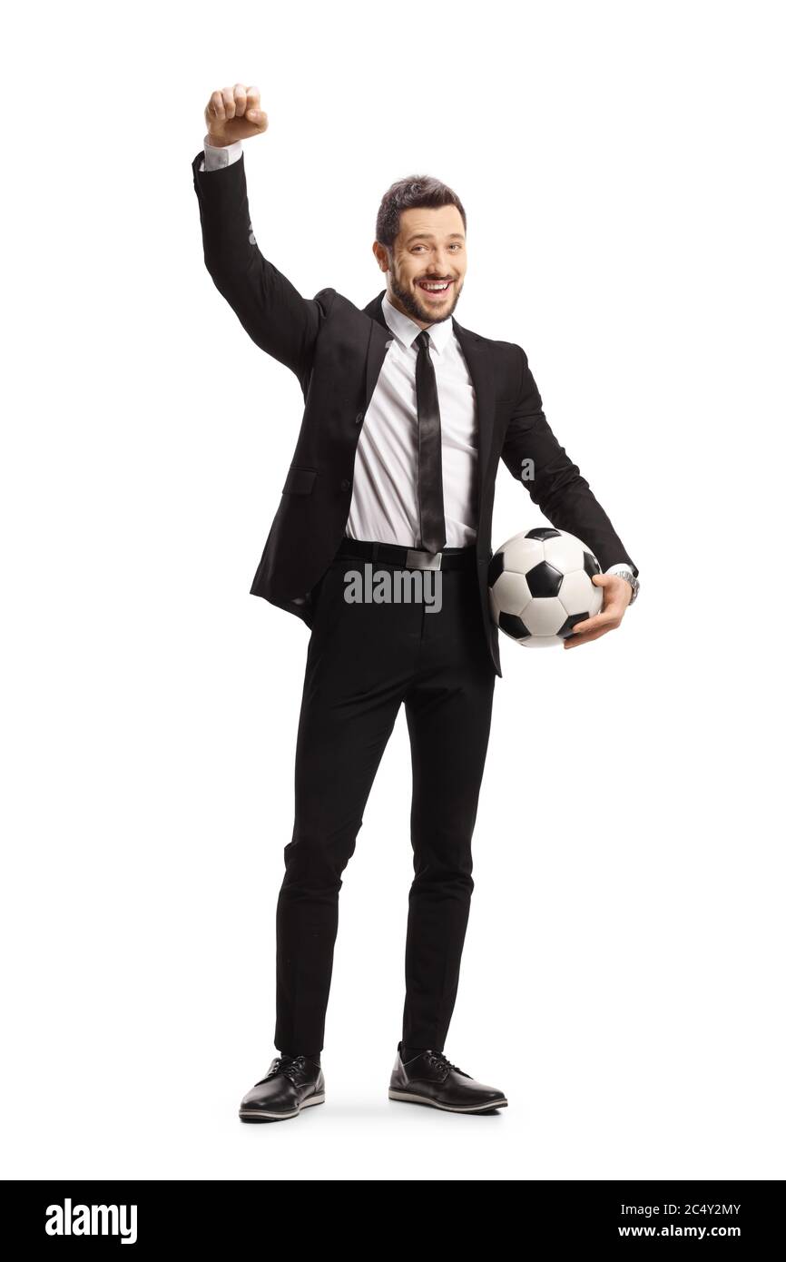 Full length portrait of a man in a black suit holding a soccer ball and ...