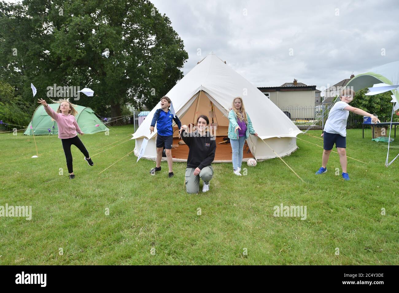 Teacher Holly Haime teaches year five pupils arts and crafts as they make paper aeroplanes inside a teepee style tent at Llanishen Fach Primary School in Cardiff. Stock Photo