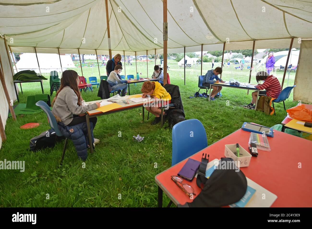 Teacher Claire Juniper teaches maths to year six students inside a socially distanced classroom setting in a tent outside on the school playing fields at Llanishen Fach Primary School in Cardiff. Stock Photo