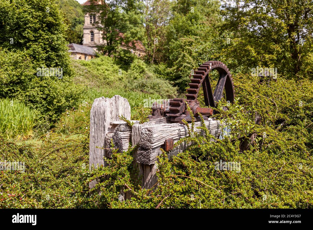 Old machinery on the Thames and Severn Canal below Christ Church at Chalford, Gloucestershire UK Stock Photo