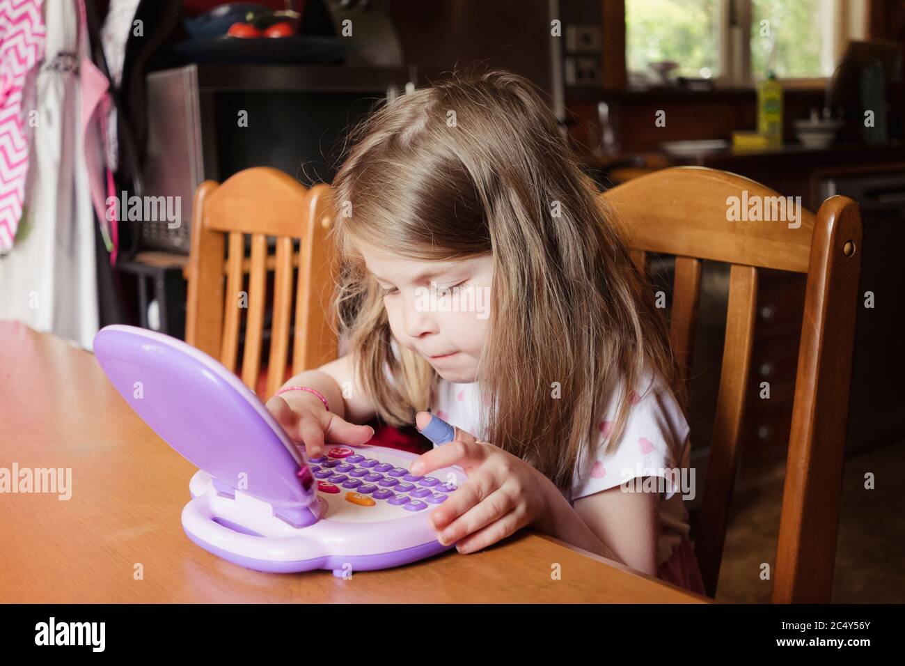 Young girl playing on preschool tablet Stock Photo