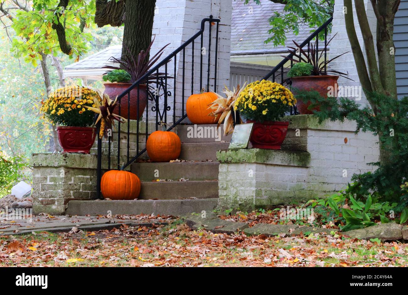 Main entrance stair and porch of the old house decorated for autumn holidays season. Halloween concept. Fall background. Stock Photo