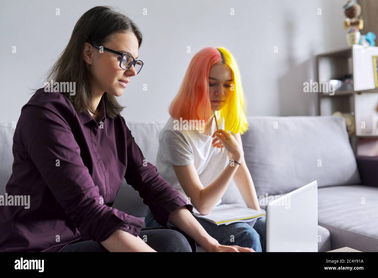 Teen student girl 15, 16 years old has individual lesson from young woman teacher Stock Photo