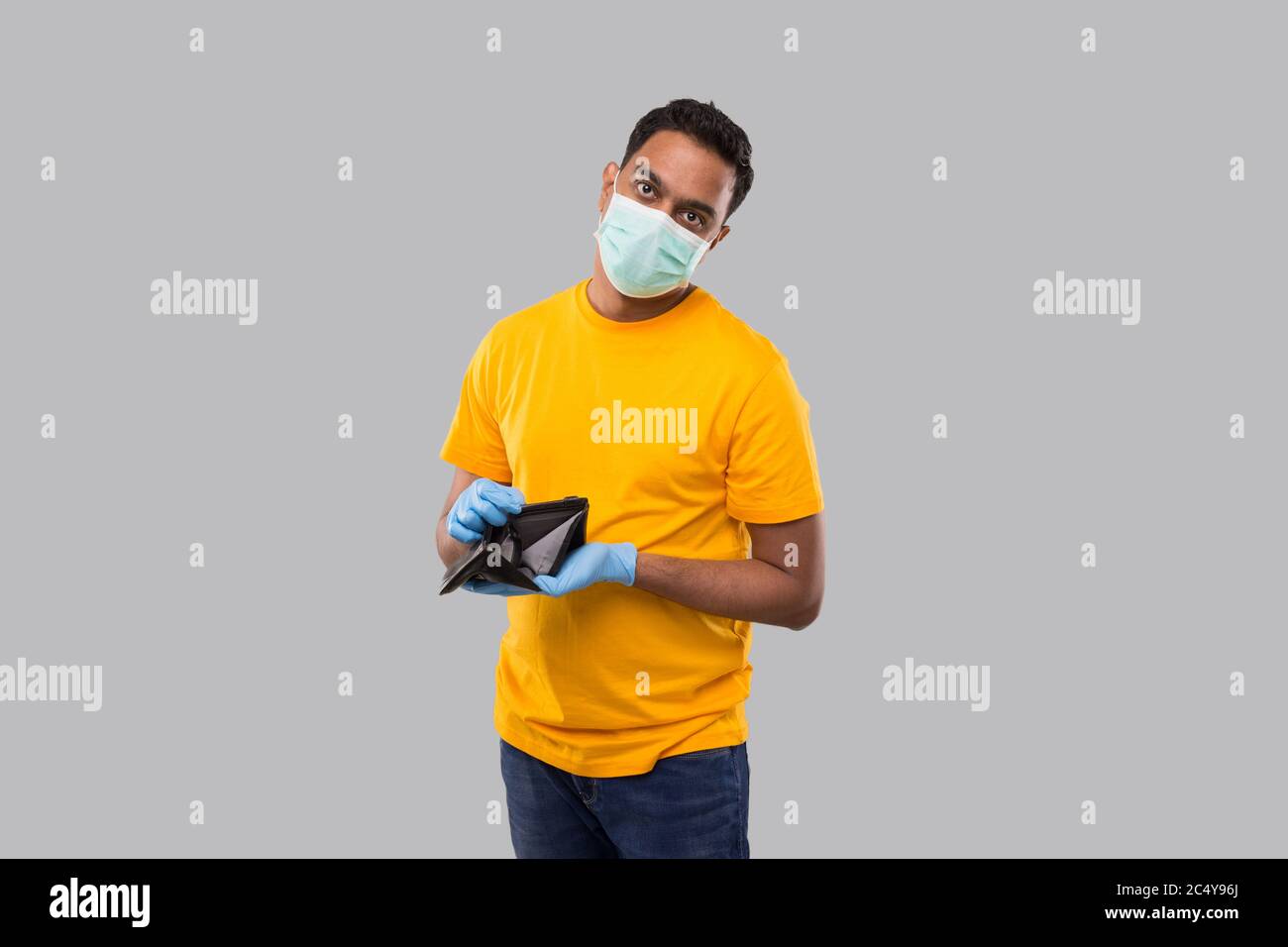 Man Watching Empty Wallet Wearing medical mask and Gloves. No Money Concept. No Salary Stock Photo
