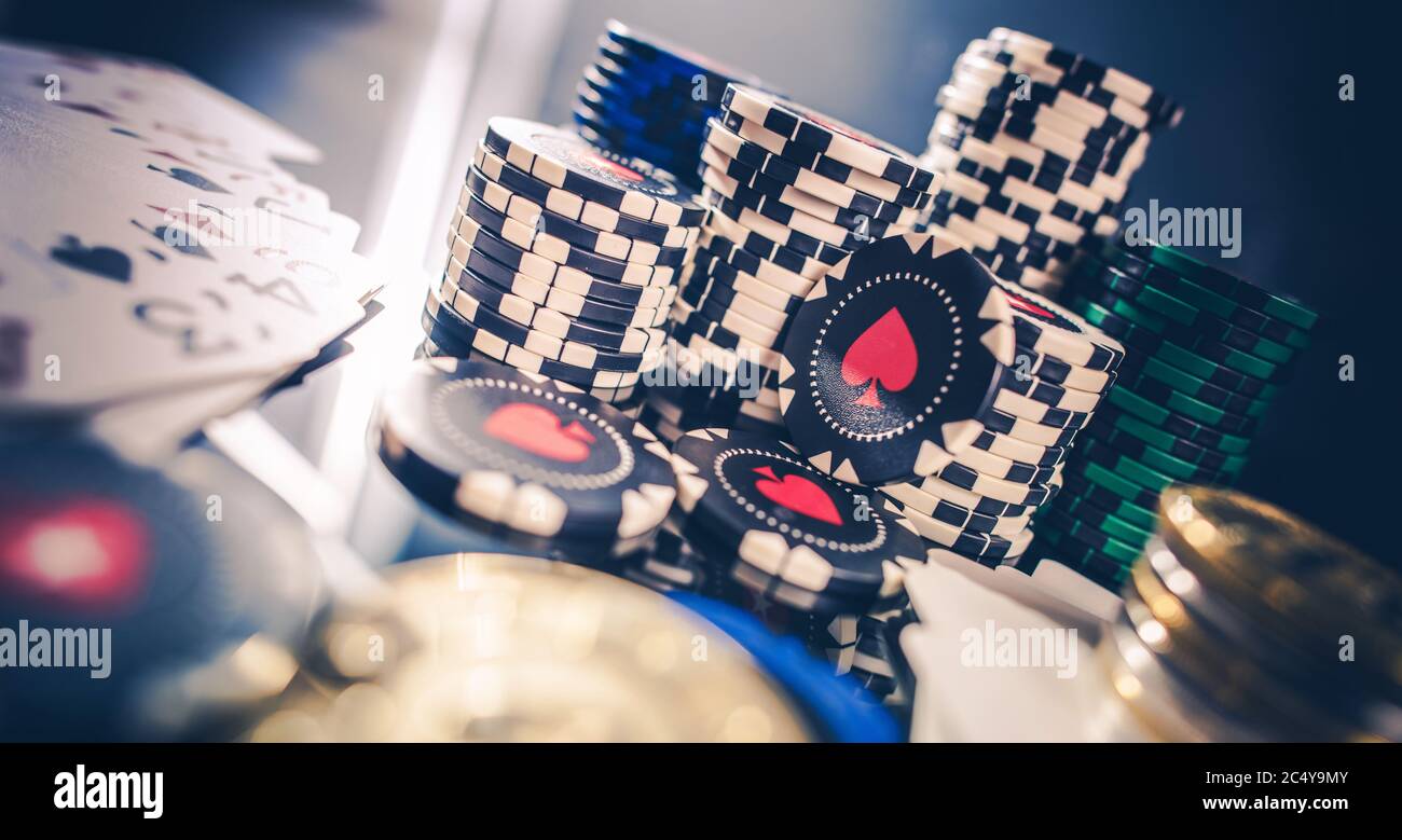 Stacks Of Different Color Poker Chips On Glass Table With Few Playing