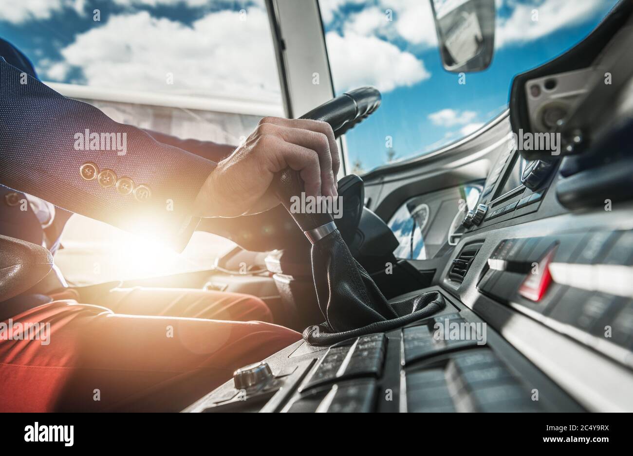 Professional Coach Bus Driver In Cabin Steering Wheel And Switching