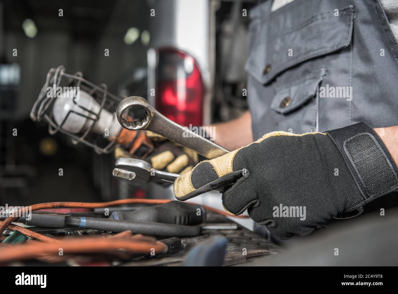 Male Auto Mechanic Picking Correct Tools To Fix Coach Bus In Vehicle