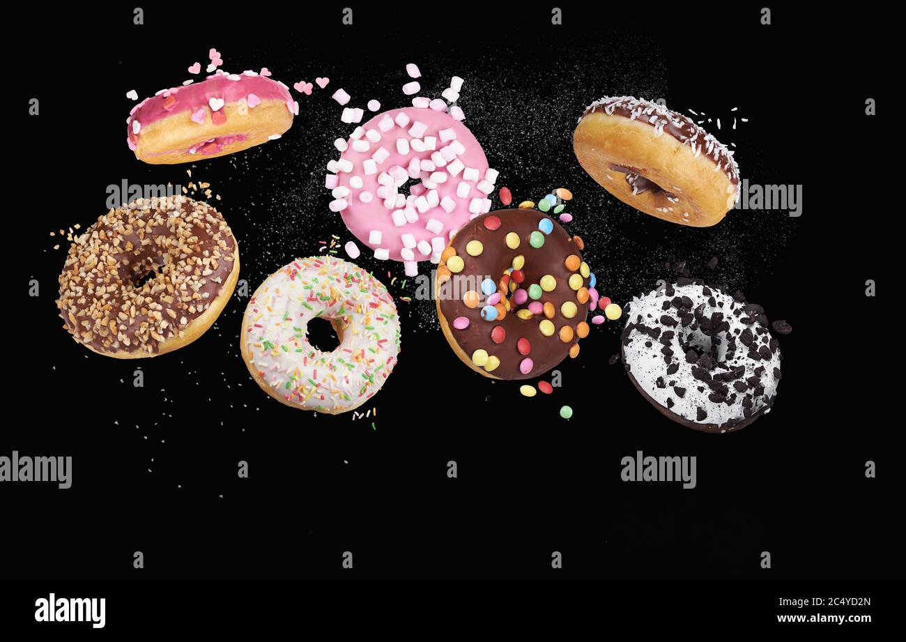 colorful donuts on black background Stock Photo