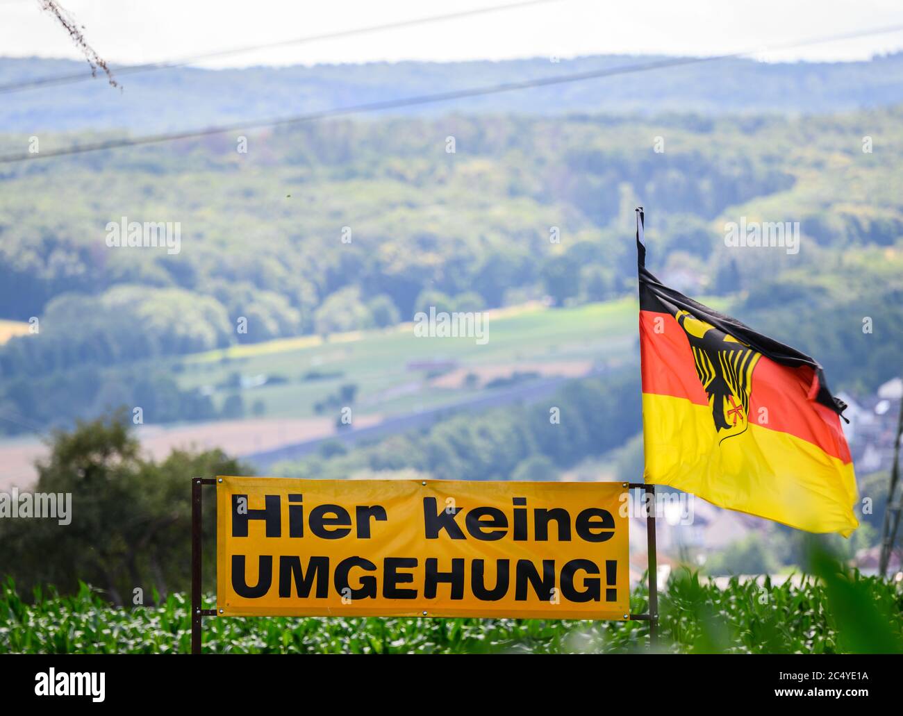 Limburg, Germany. 29th June, 2020. Residents express their protest against the traffic planning with a German flag and a poster 'No bypass here' in the industrial area 'Im Kraicher Ahl'. Credit: Andreas Arnold/dpa/Alamy Live News Stock Photo
