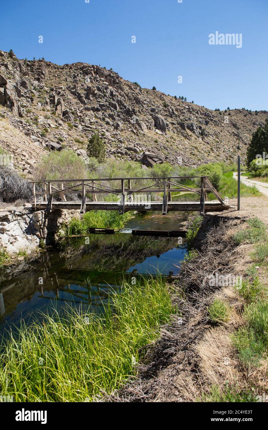 Old rickety wooden bridge over lower rock creek below Long Valley Dam and Crowley Lake Stock Photo