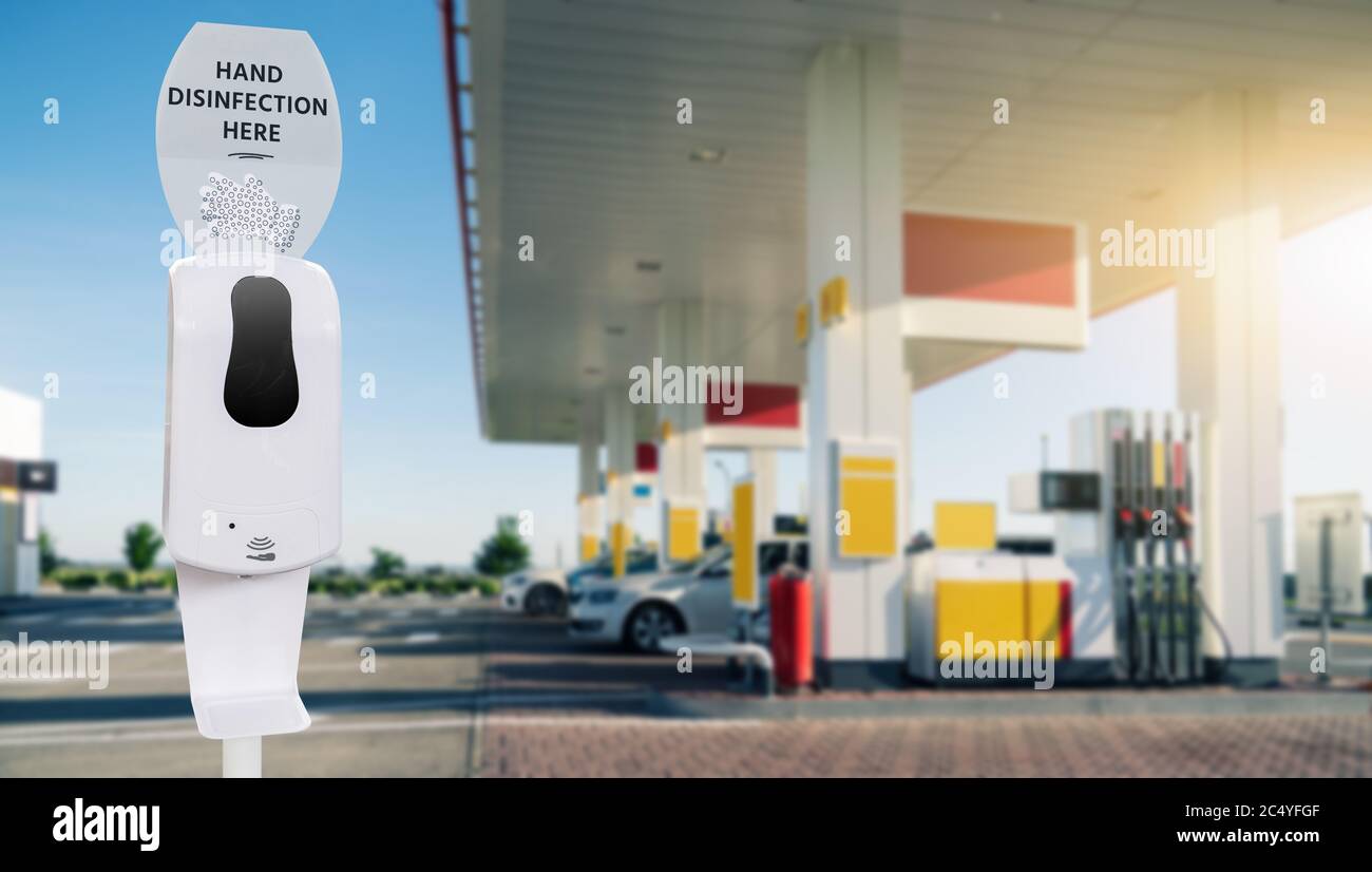 Contactless disinfection for hands on a gas station during the coronavirus pandemic Stock Photo