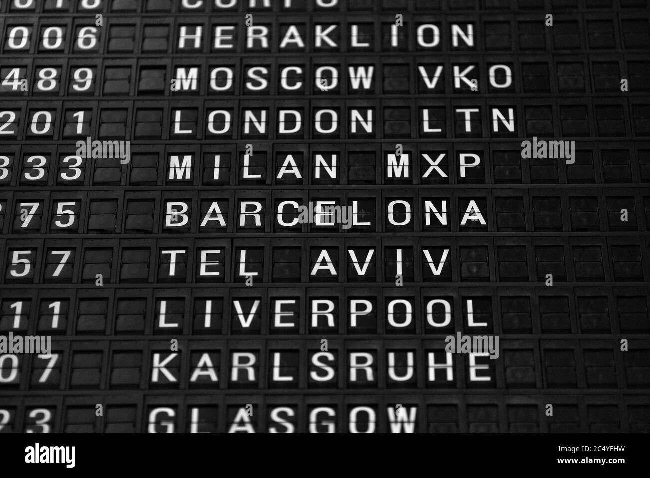 Departures board at the airport. Flight information mechanical timetable. Split flap mechanical departures board. Flight schedule. Stock Photo