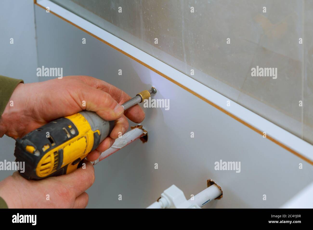 A new bathroom furniture carpenter installing a new bathroom wood