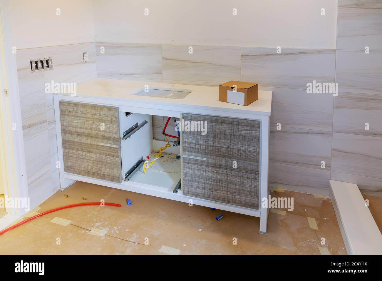 Remodeling renovation in furniture bathroom, a man is installing