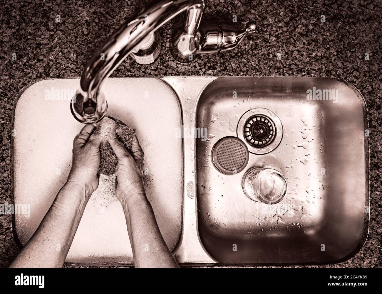 washing dishes, two sink, hands in soapy water Stock Photo Alamy