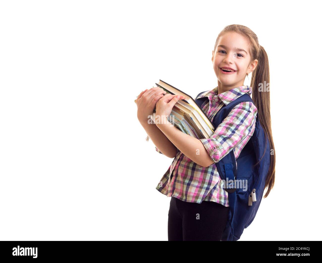 Smiling schoolgirl looking in camera and holding books Stock Photo - Alamy
