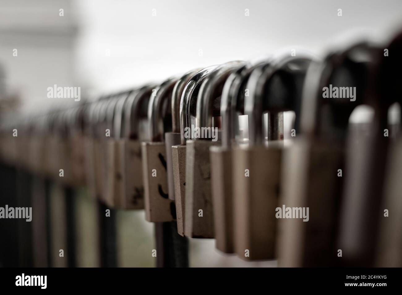 A large number of padlocks attached to the fence Stock Photo