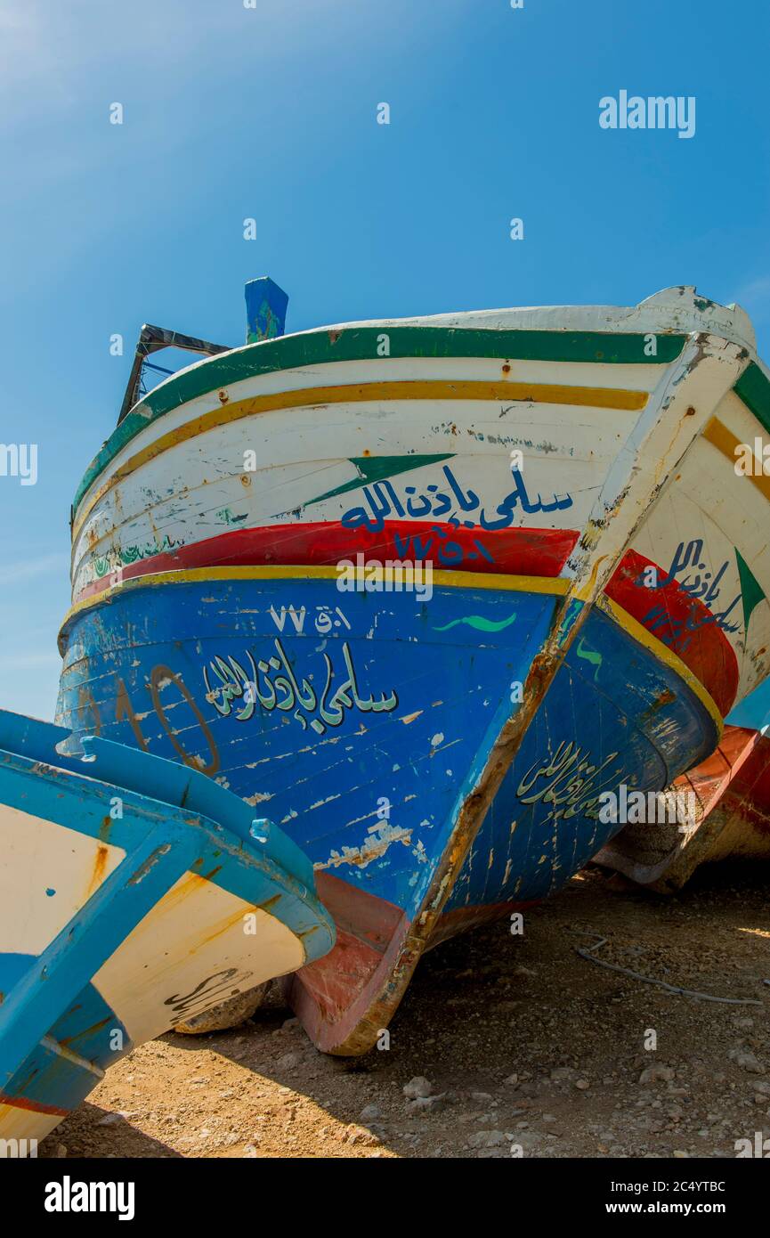 Seized wooden boats from Libya on which illegal migrants come to Europe in the harbor of Portopalo di Capopassero, a fishing community on the island o Stock Photo