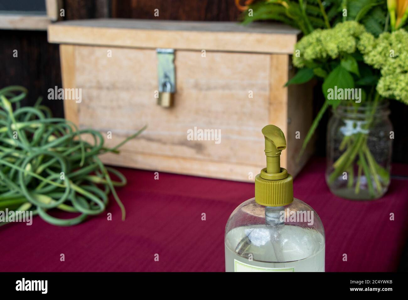 Close up on Purell hand sanitizer gel bottle on a self-serve farm stand, honor system, roadside, COVID-19 Pandemic Stock Photo