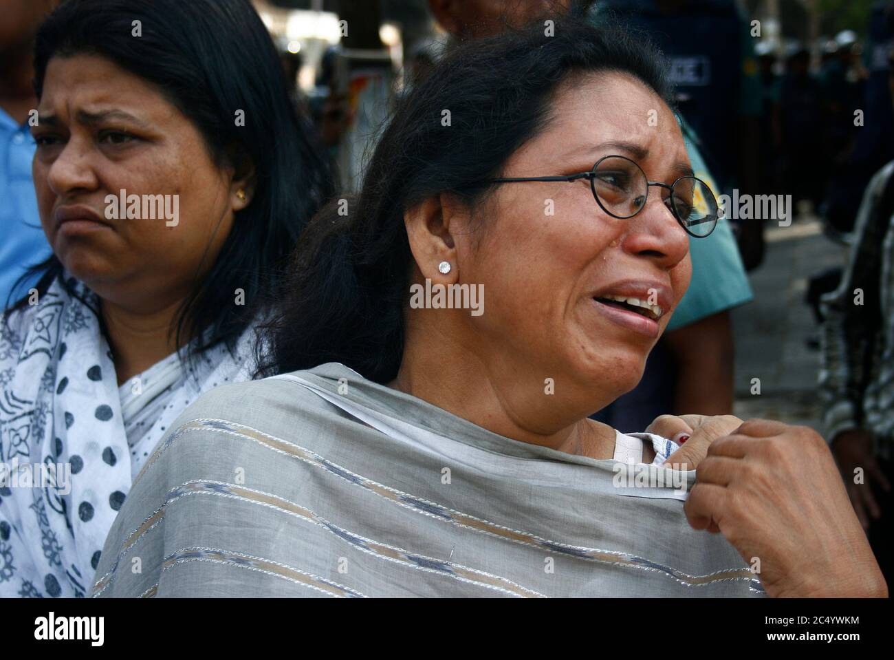 A woman outside the BDR Headquarters gate mourns for her family who are still stuck inside the BDR compound. Pilkhana, Dhaka, Bangladesh. February 26, Stock Photo