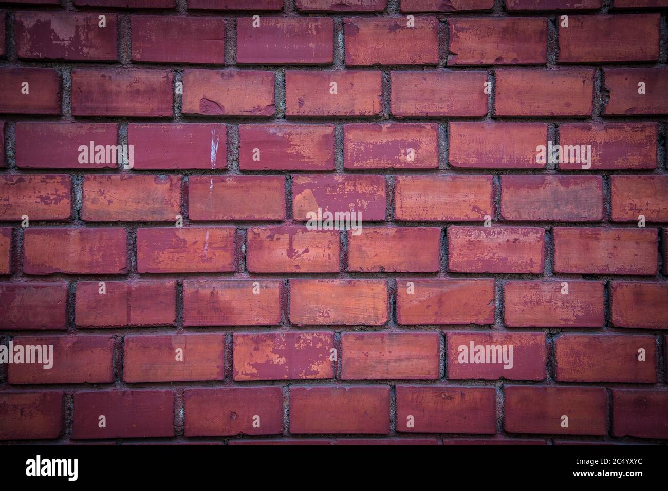 Detail of red brick wall background with dark vignette in corners Stock Photo