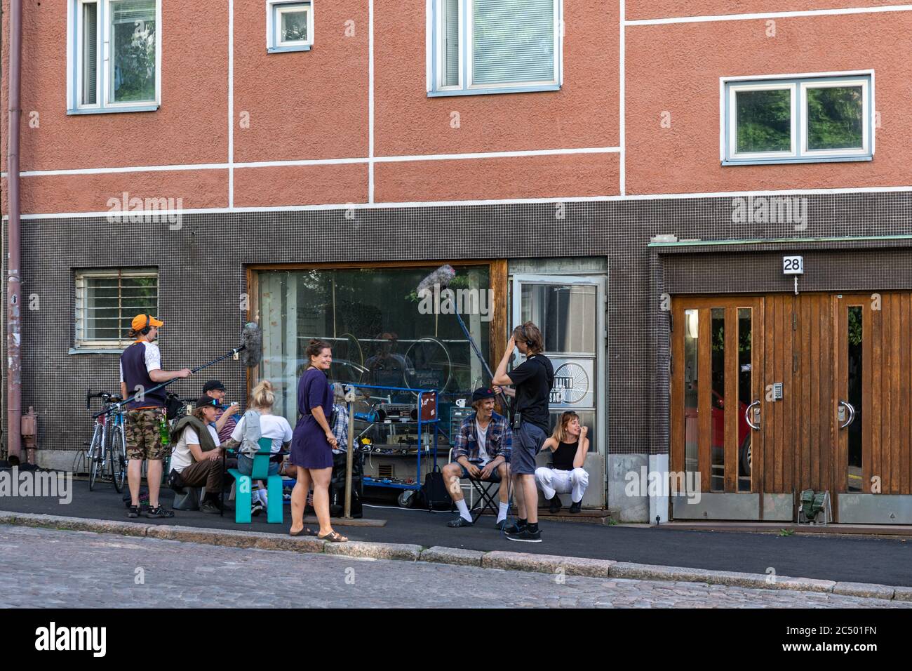 Film crew shooting Aikuiset comedy series episode in front of Neljäs Linja 28 in Kallio district of Helsinki, Finland Stock Photo