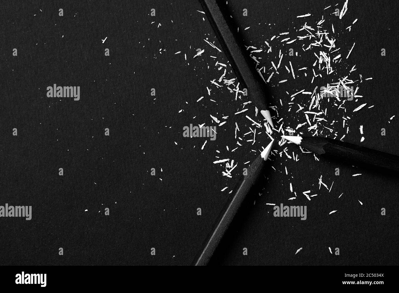 Black, colored pencils, on black background, and shavings from the