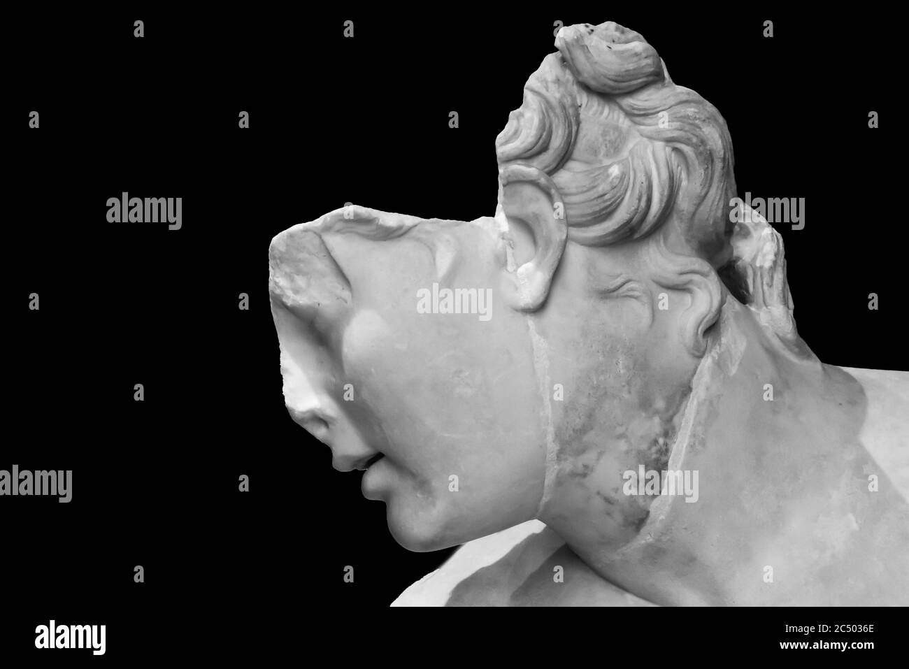 Black and white photo on close-up of profile of broken head of ancient roman statue in ruins Stock Photo