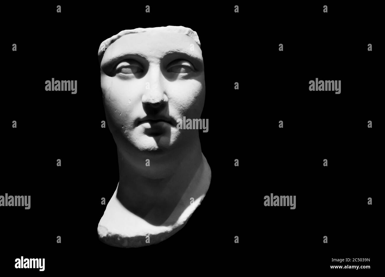 Black and white photo in close-up on face of ancient roman statue in ruins Stock Photo