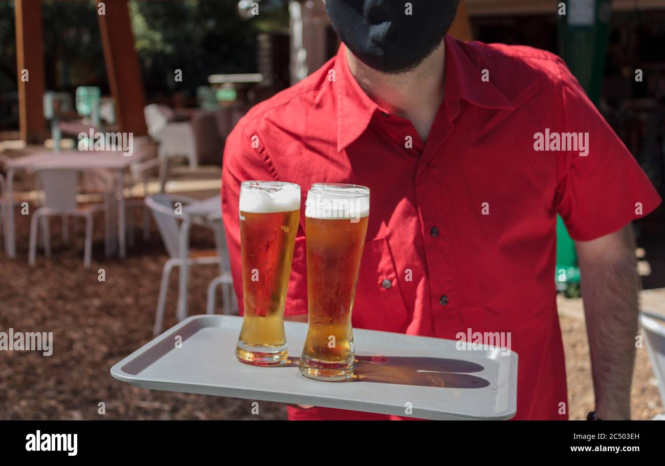 Waiter holding tray beer glass hi-res stock photography and images - Alamy