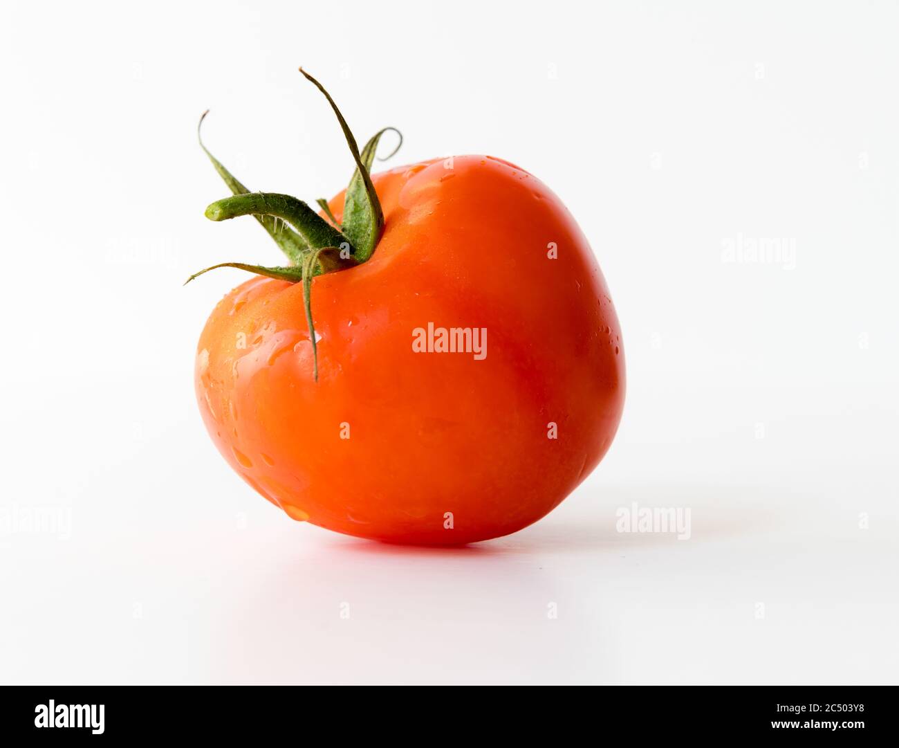 A vine tomato isolated with a white background Stock Photo - Alamy