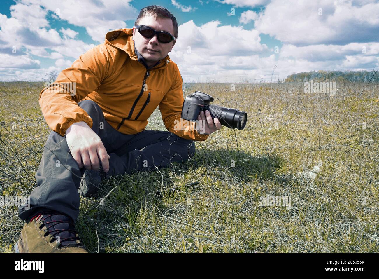 Wild life Nature photographer take a picture in field Stock Photo